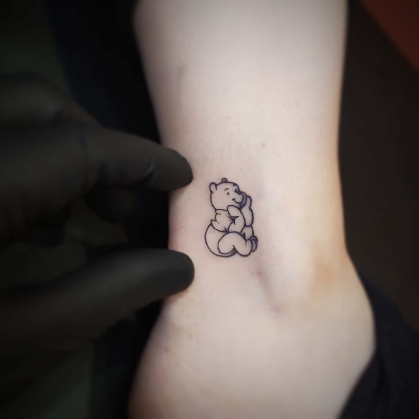 Tatuaje pequeño de Winnie the Pooh -michaelsugartattoo