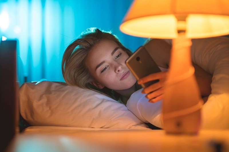 Woman Reading Text Message At Night