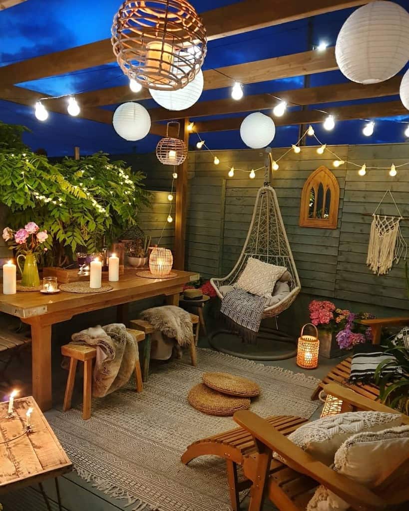 backyard patio wood table hanging lights candles 