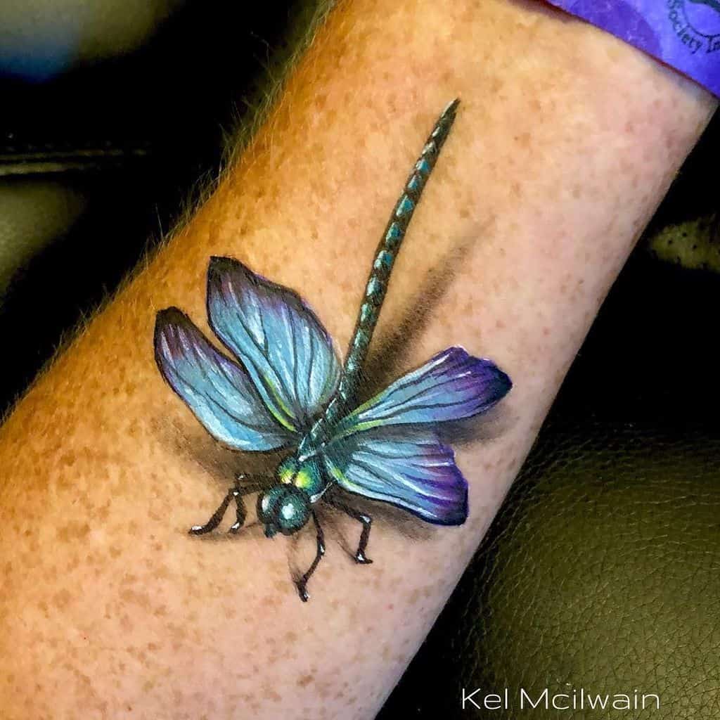 The blue and green accented dragonfly in the 3D image posing the freshness of life 