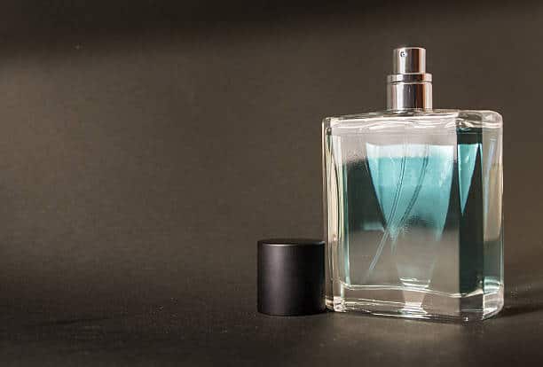 An unused fresh bottle of aftershave with a black lid