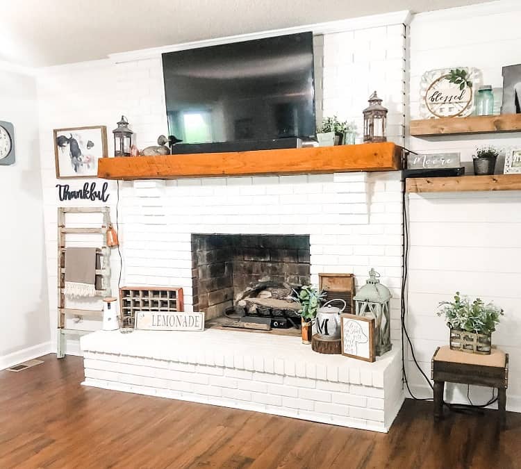 white brick fireplace wood mantle tv