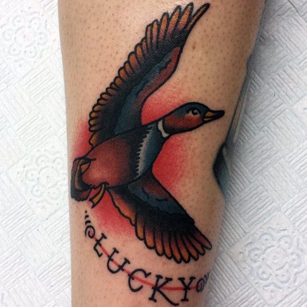 American Traditional Lucky Tattoo With Flying Mallard On Man.