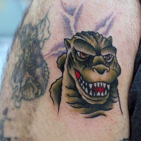 American Traditional Style Tattoo Of Godzilla Head On Man