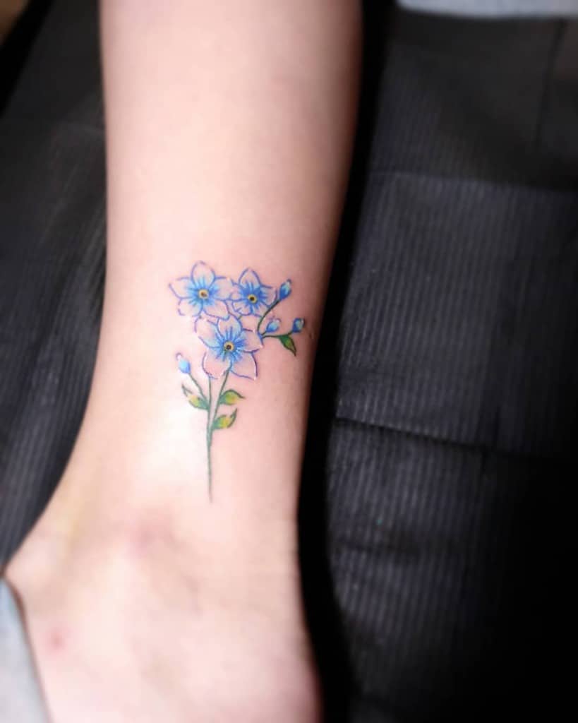 Watercolor forgetmenot tattoo on the wrist