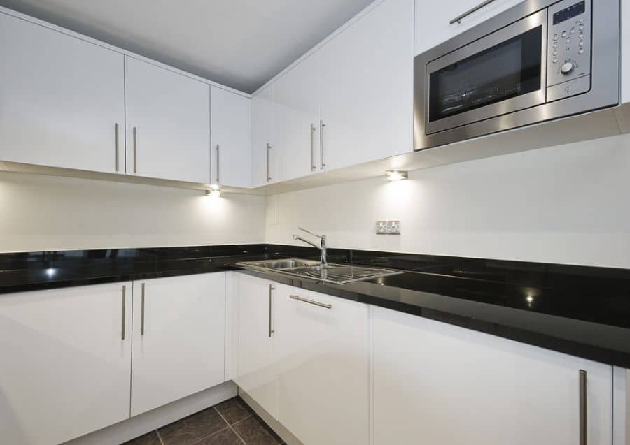 simple white kitchen cabinets black granite countertop 