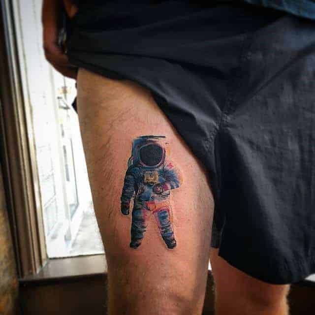 astronaut-small-thigh-tattoo-on-man