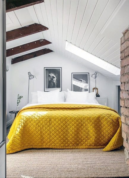 yellow bed in attic guest bedroom 