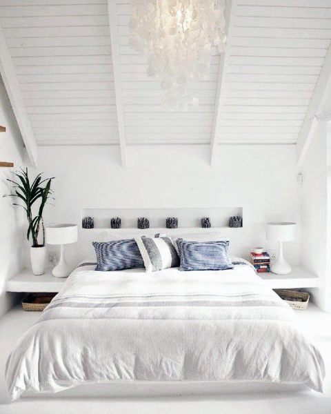 small white master bedroom with chandelier
