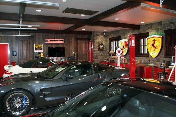 modern garage with stone and wood panel wall ferrari sign sports cars
