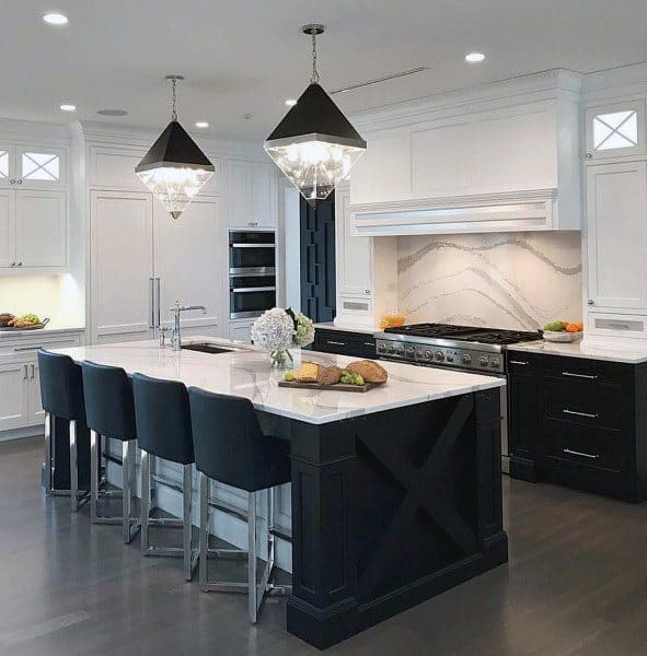 white and black two tone kitchen island with four black chairs and marble countertop 