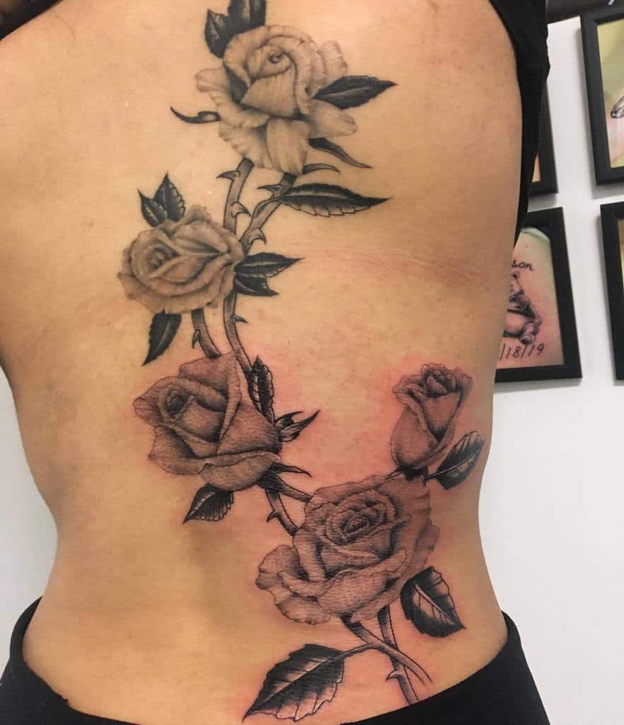 rose vine side tattoos
