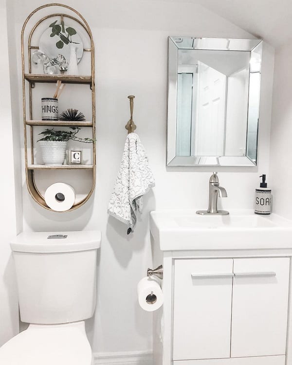 modern white bathroom with gold shelving