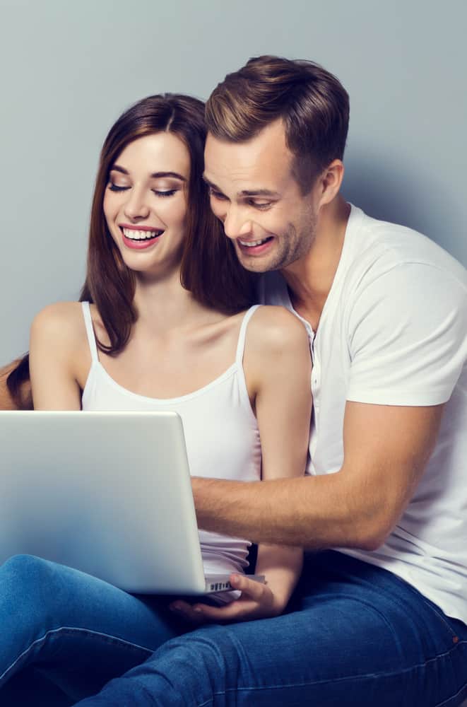 beautiful couple using laptop