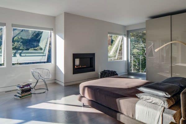 modern bedroom concrete floor fireplace