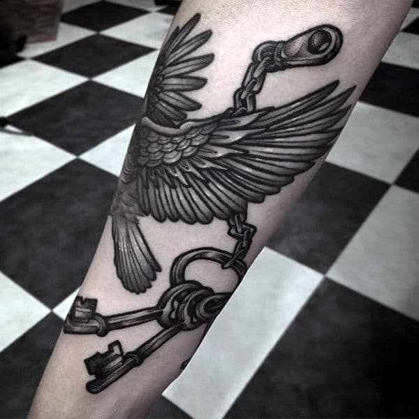 Bird Carrying Keys Male Tattoo On Lower Arm