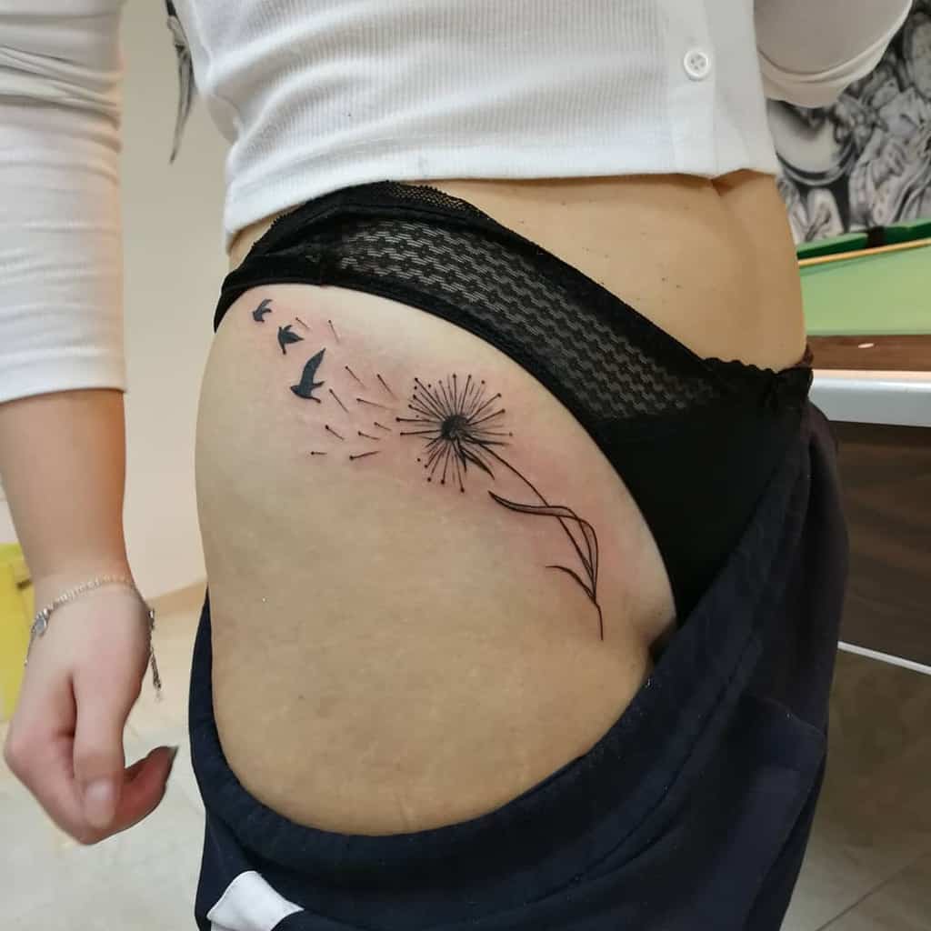 black and dandelion tattoo