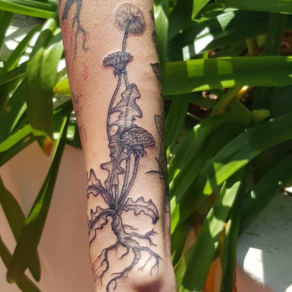black and grey dandelion with leaves tattoo