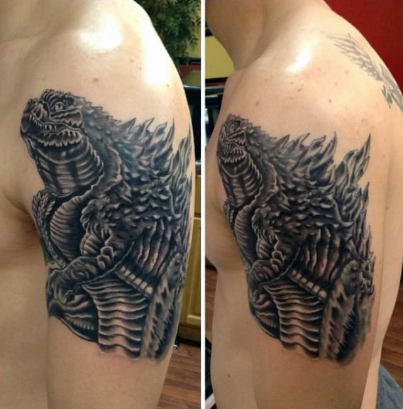 Black And Grey Neo Traditional Tattoo Of Godzilla On Mans Bicep