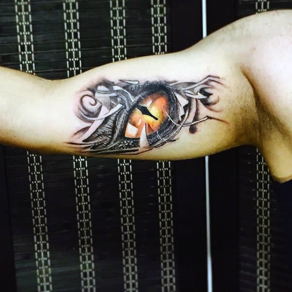 Black And White With Color Godzilla Eye Tattoo On Guys Inner Bicep