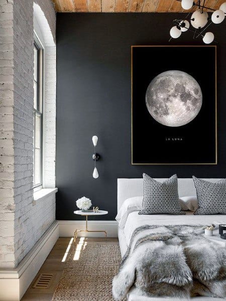 minimalist bedroom exposed white brick black feature wall moon artwork 