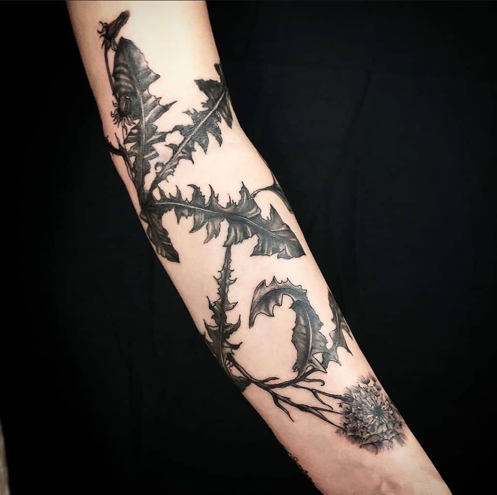 black dandelion sleeve tattoo