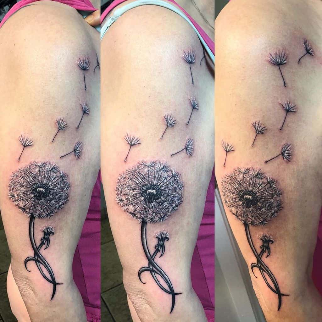 black dandelion tattoo on arm