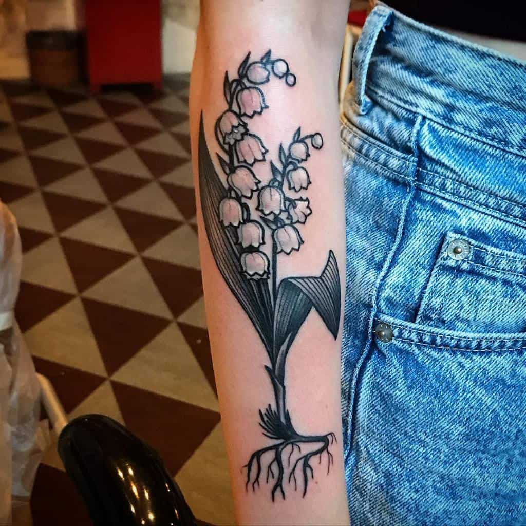 black-gray-forearm-lily-of-the-valley-tattoo-studiomerentis