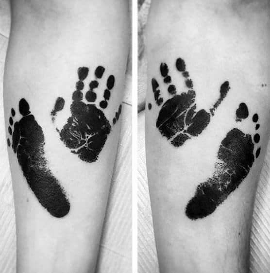 Black Ink Footprint And Handprint Mens Forearm Tattoo Designs