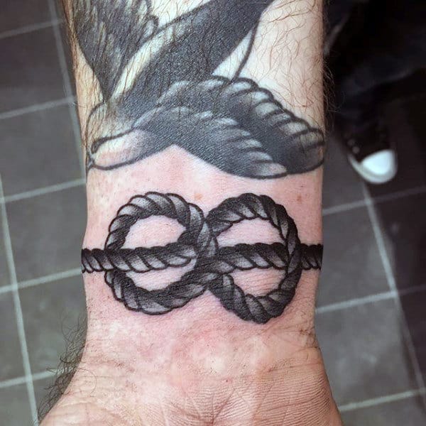 Black Ink Male Wrist Traditional Knot Tattoo