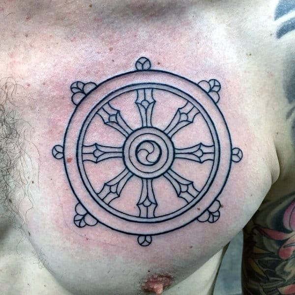 Black Ink Outlien Dharma Wheel Tattoo On Mans Upper Chest