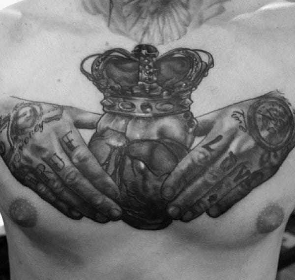 Black Ink Shaded Claddagh Tattoos Designs On Chest For Men