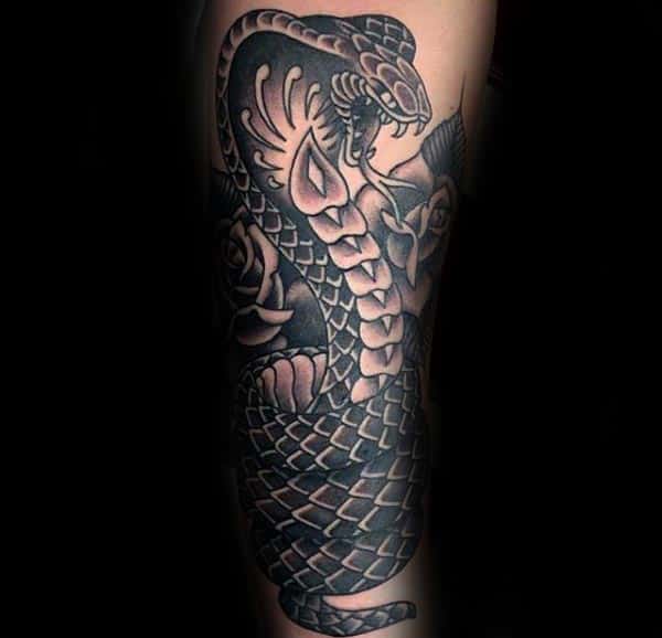 Black Ink Shaded Cobra Tattoo On Males Forearm