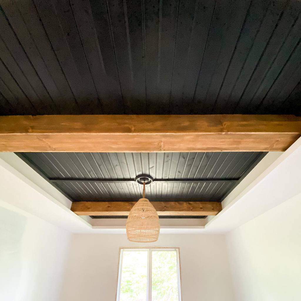 black low basement ceiling with exposed wood beams
