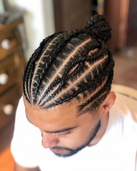 A twist hairstyle for men with twisted hair from the front and ending into a man bun at the crown