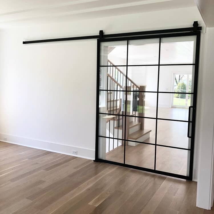 black metal frame with glass panels french barn door