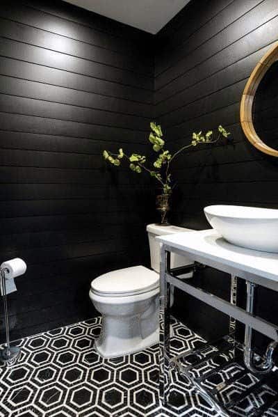 black shiplap wall bathroom with white and black tile floor
