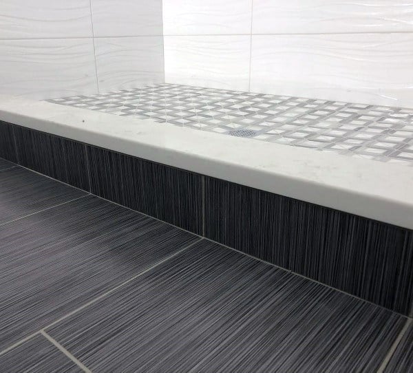 Black Tile Bathroom Floor With White Marble Shower Curb Design