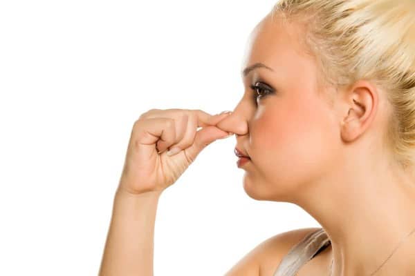 blonde woman toucher her nose