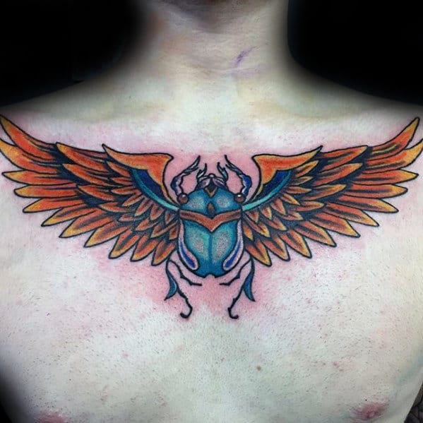 blue and orange scarab wings mens upper chest tattoo ideas