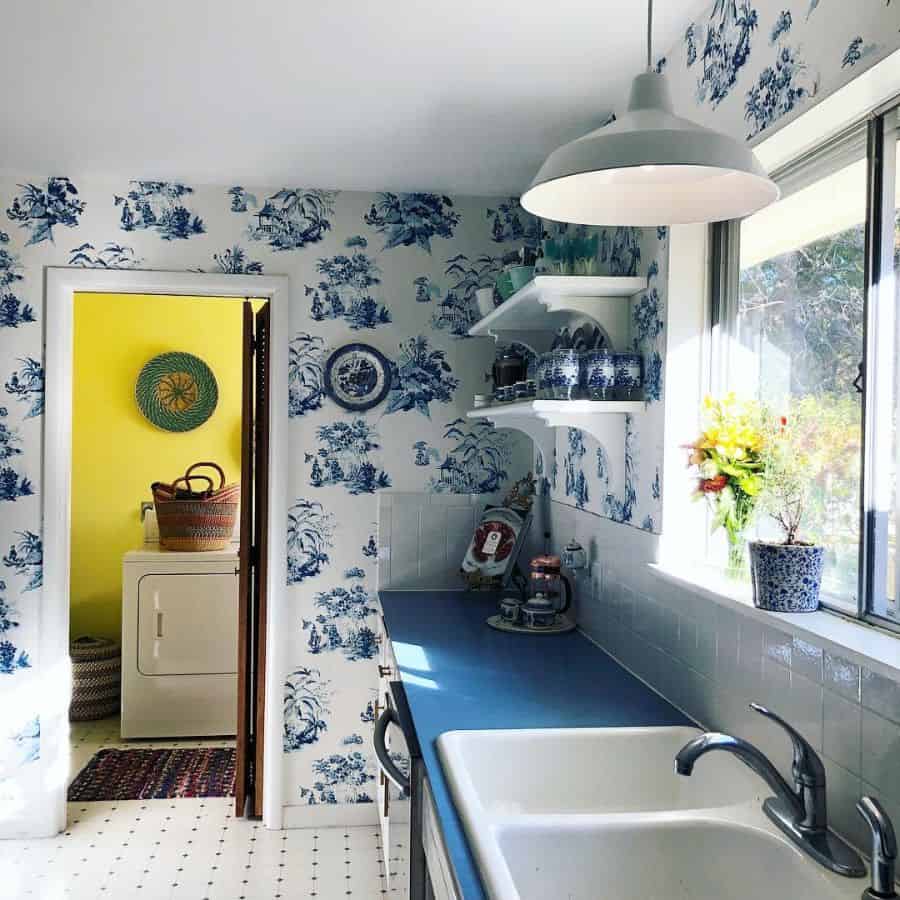 blue forest wallpaper small kitchen with blue countertop white wall shelves 