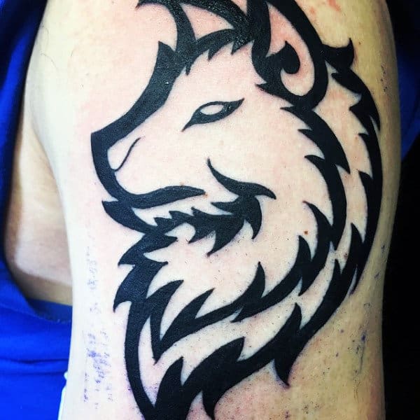 Bold Black Ink Tribal Wolf Male Upper Arm Tattoo