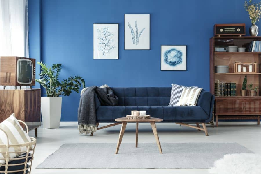 retro living room with blue accent wall and sofa