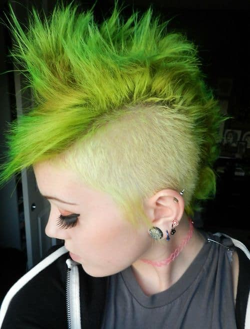 A cyber punk Mohawk haircut with top hair shaded green for bold look