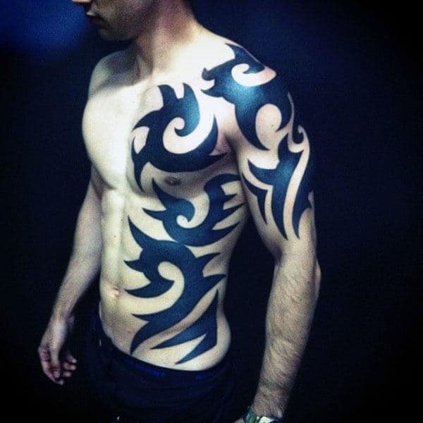 Bold Tribal Chest And Arm Tattoo Designs For Men With Black Ink