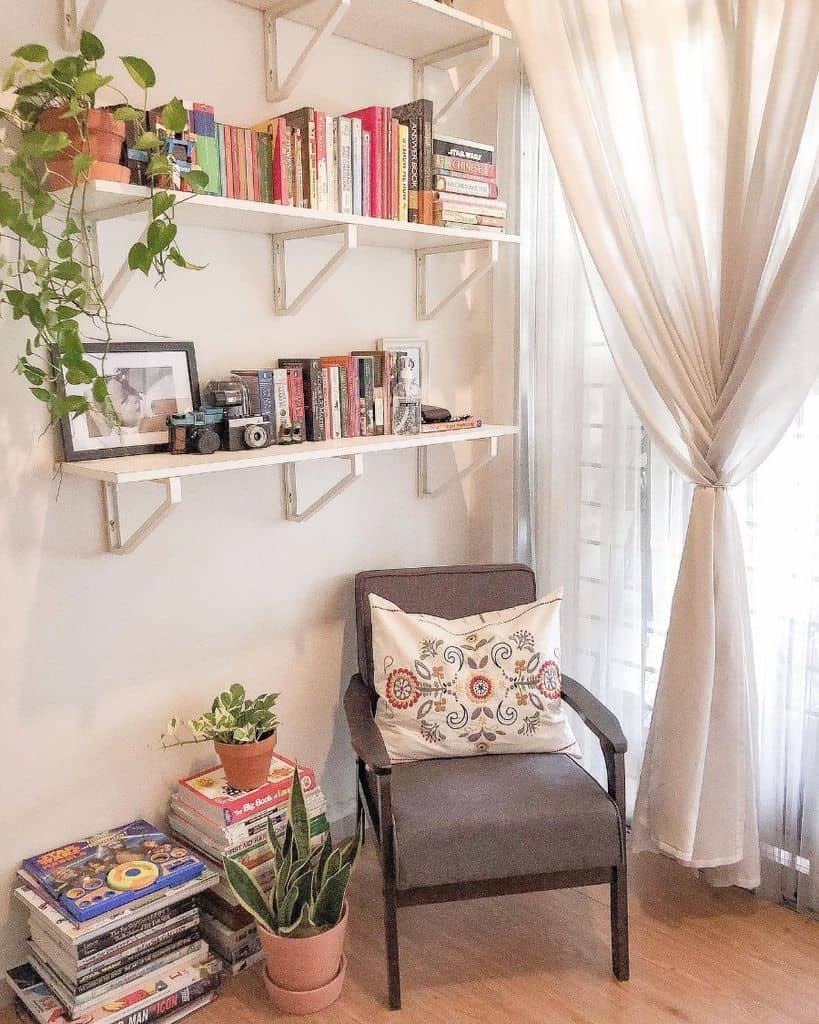 small corner living room reading nook with wall shelves 