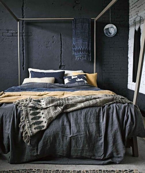 industrial black bedroom with exposed brick walls