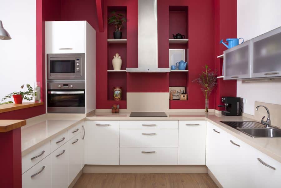 red wall accent shelves white cabinet kitchen 