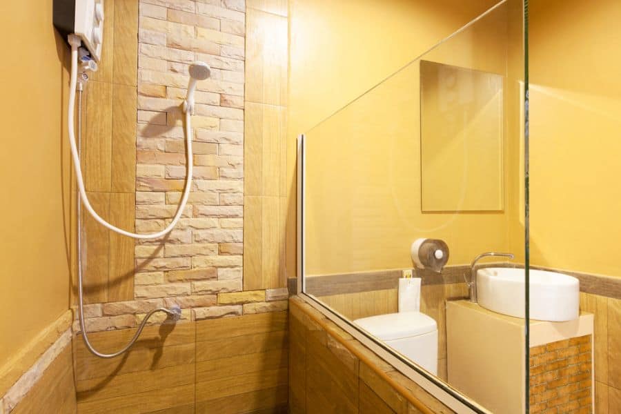 mustard bathroom with glass shower 