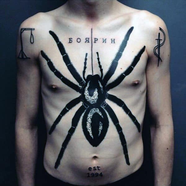 Brilliant Black Spider Tattoo On Torso For Males With Lettering